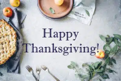 the words happy thanksgiving on a marble slab with silverware and pie
