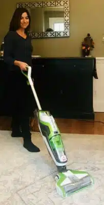 A woman vacuuming with the CrossWave Vacuum