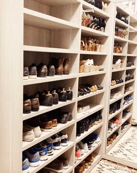 a built-in wall of shelving for shoes