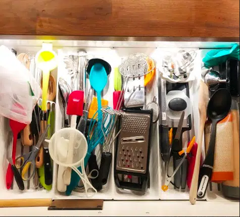 a disorganized utensil drawer