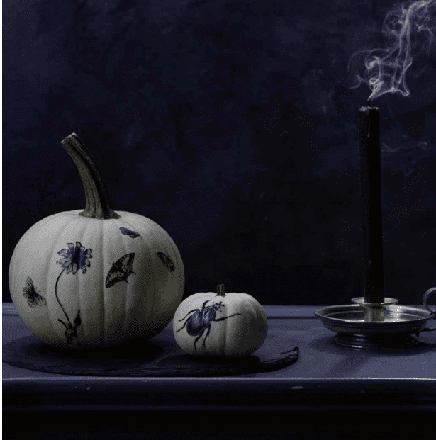 white decorated pumpkins on a black background