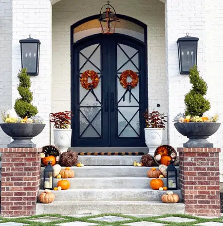 a holiday entryway with fall decor