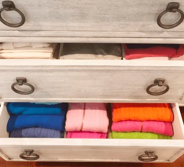 folded sweaters in a dresser