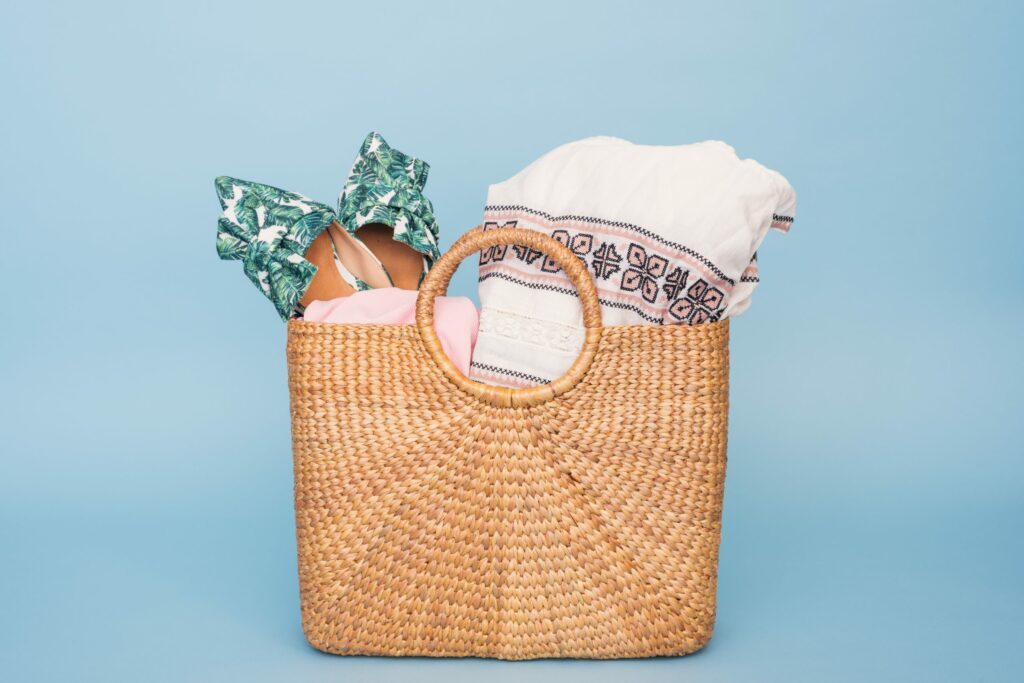 a wicker tote with beach supplies