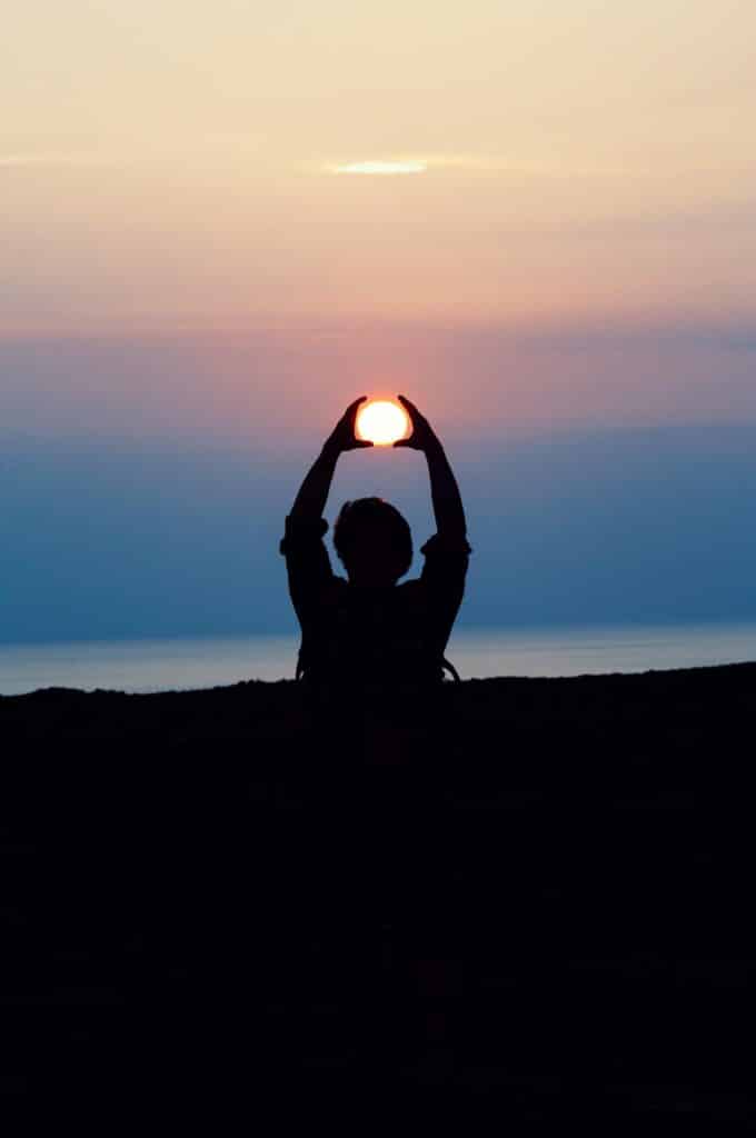 person holding the sun in a yoga position