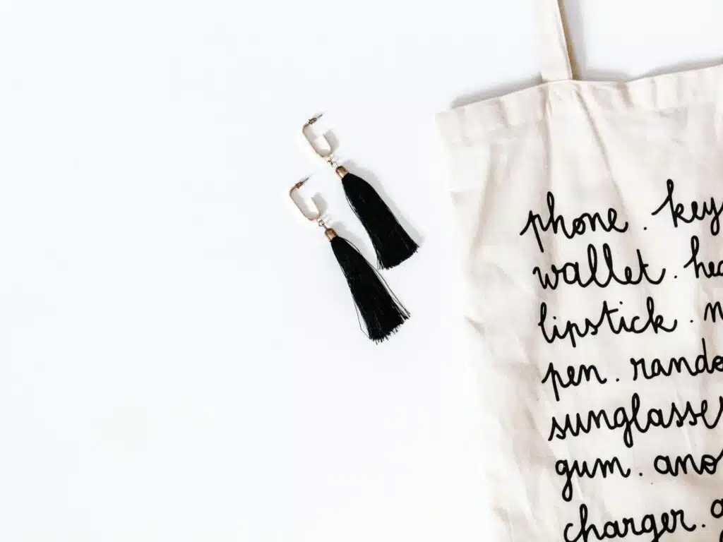 white canvas tote with black script writing