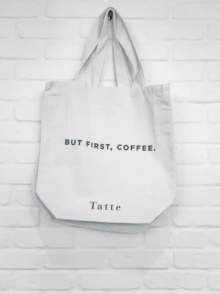 a white canvas tote with the words But first, Coffee on it