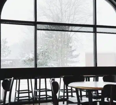 glass restaurant wall opening to a snowy day