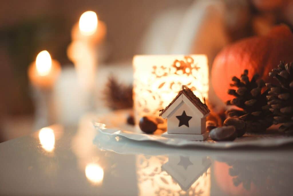 a mini house with candles in the background